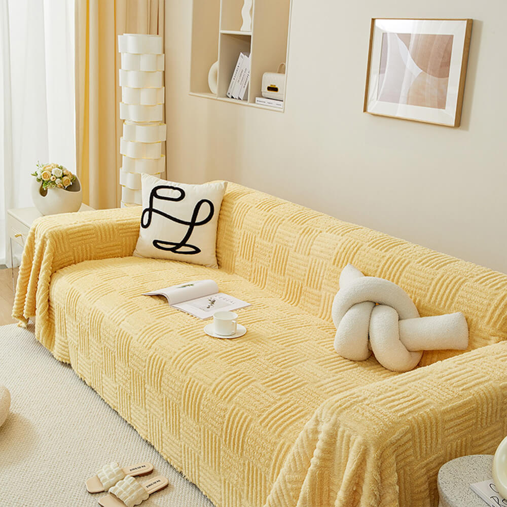 Oregelbundet rutigt randigt puffade sammetsoffatäcke