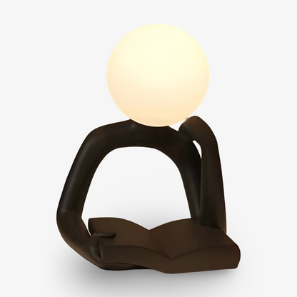 Konstnärlig bordslampa i form av en läsande figur i plast