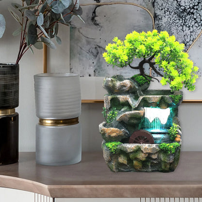 Belyst vattenfall fontän med klippträdgård och trä ornament